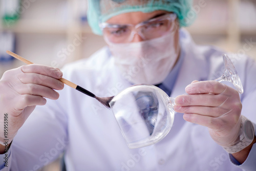 Forensics investigator working in lab on crime evidence photo