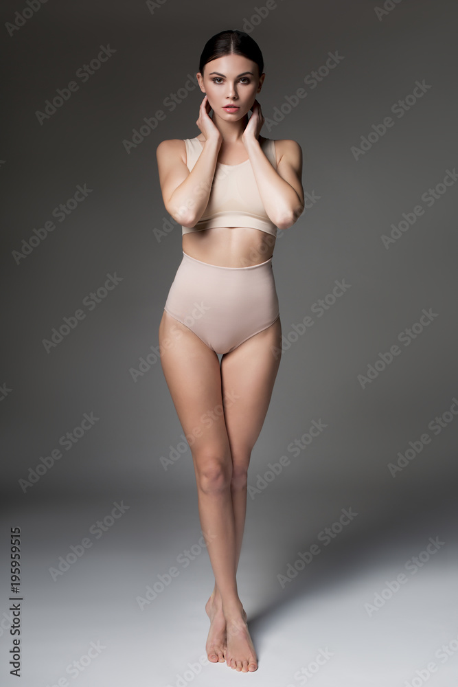 Φωτογραφία Full length portrait of confident girl standing in beige lingerie