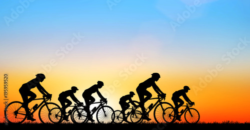 Silhouette man and bike relaxing on blurry sunrise background