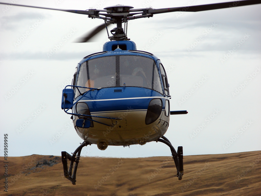 Blue helicopter on sky with clouds Blue helicopter on sky with clouds