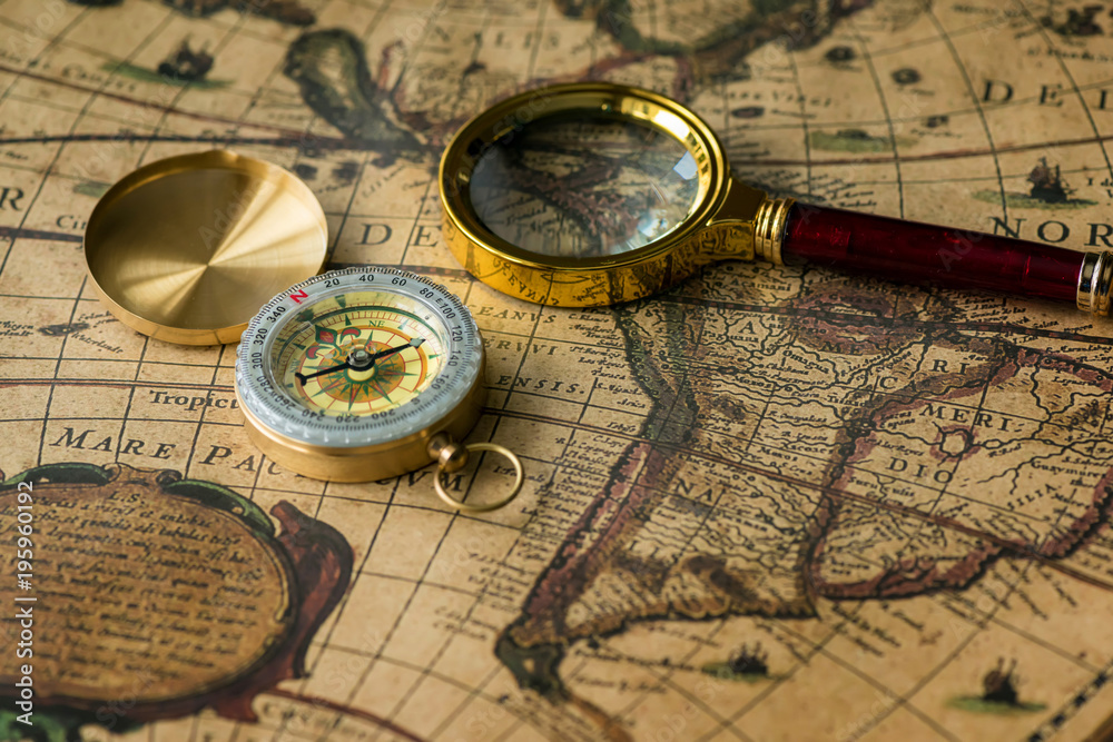 Retro compass with old map and magnifier Retro compass with old map and magnifier