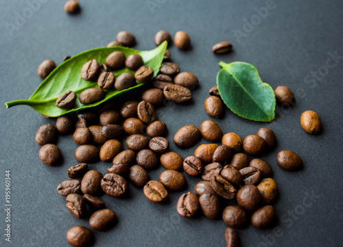 coffe beans and green leaf on black background photo
