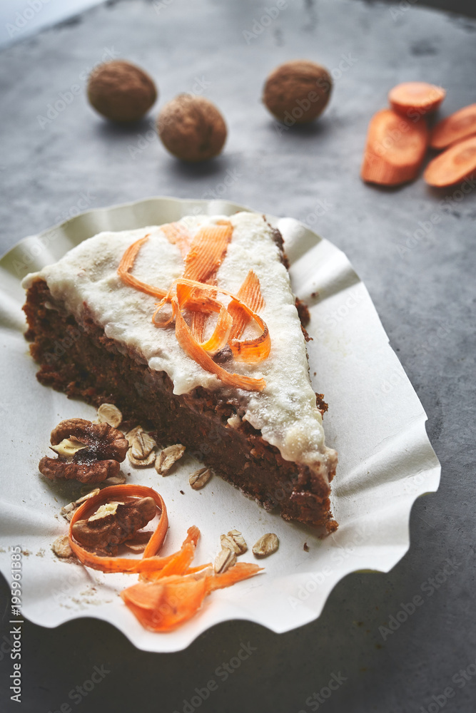 product set and cut carrot cake on the paper dish on gray concrete backdrop product set and cut carrot cake on the paper dish on gray concrete backdrop
