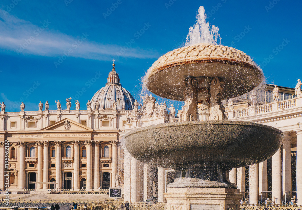 Saint Peter's Basilica and the fountain in front in Vatican City, Rome, Italy
