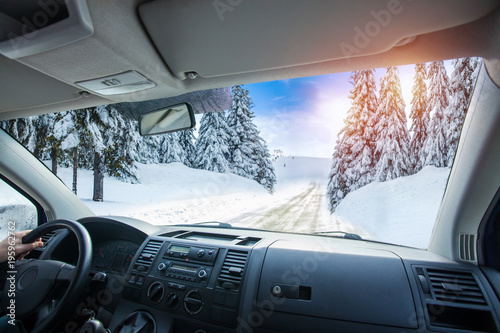 Car dashboard and steering wheel inside of car. winter landscape. Travel concepte