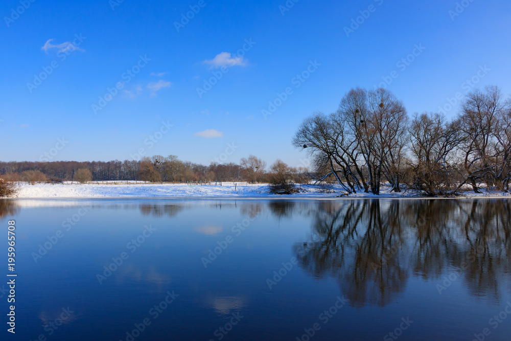 Water surface of the winter river against blue sky. Winter landscape
