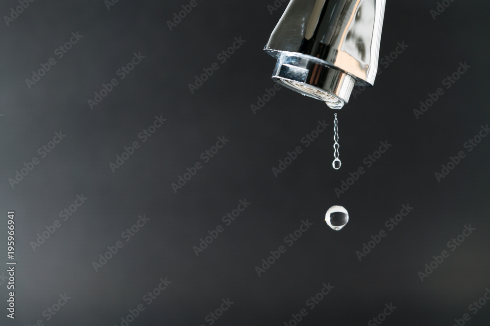 water drop on faucet with black backgrounds, world water day concept with copy space water drop on faucet with black backgrounds, world water day concept with copy space