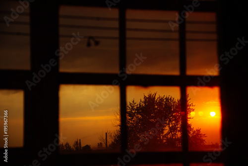Landscape  fiery  bright sunset in the window