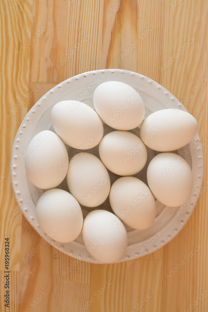White eggs on a wooden background