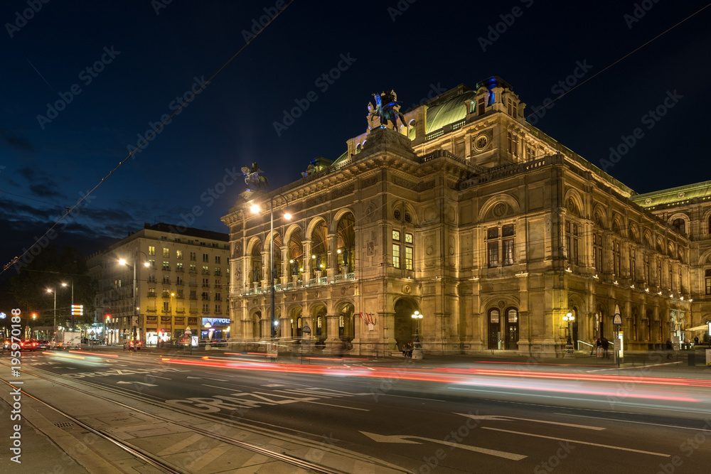 Wide shot of traffic passing the Vienna Opera House