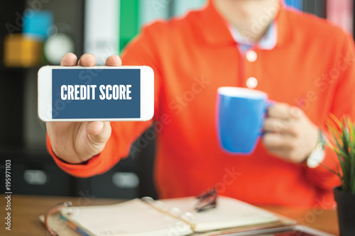 Young man showing smartphone and CREDIT SCORE word concept on screen