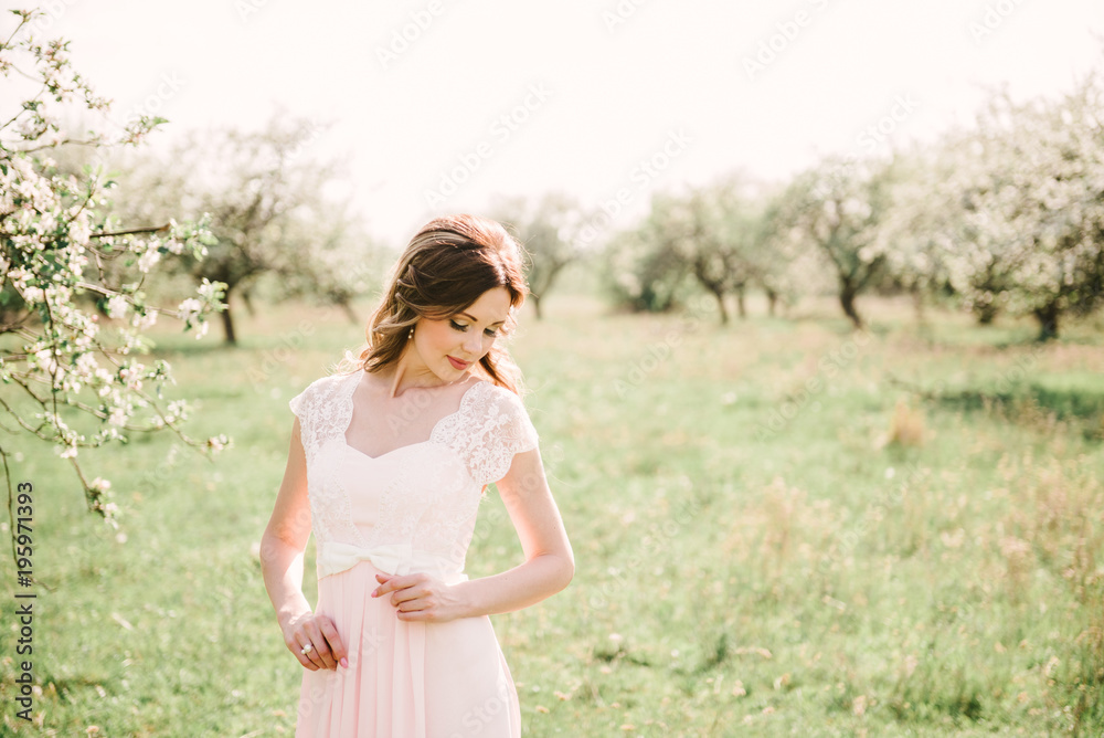 Portrait of a beautiful girl in the garden of blossoming apple trees Portrait of a beautiful girl in the garden of blossoming apple trees
