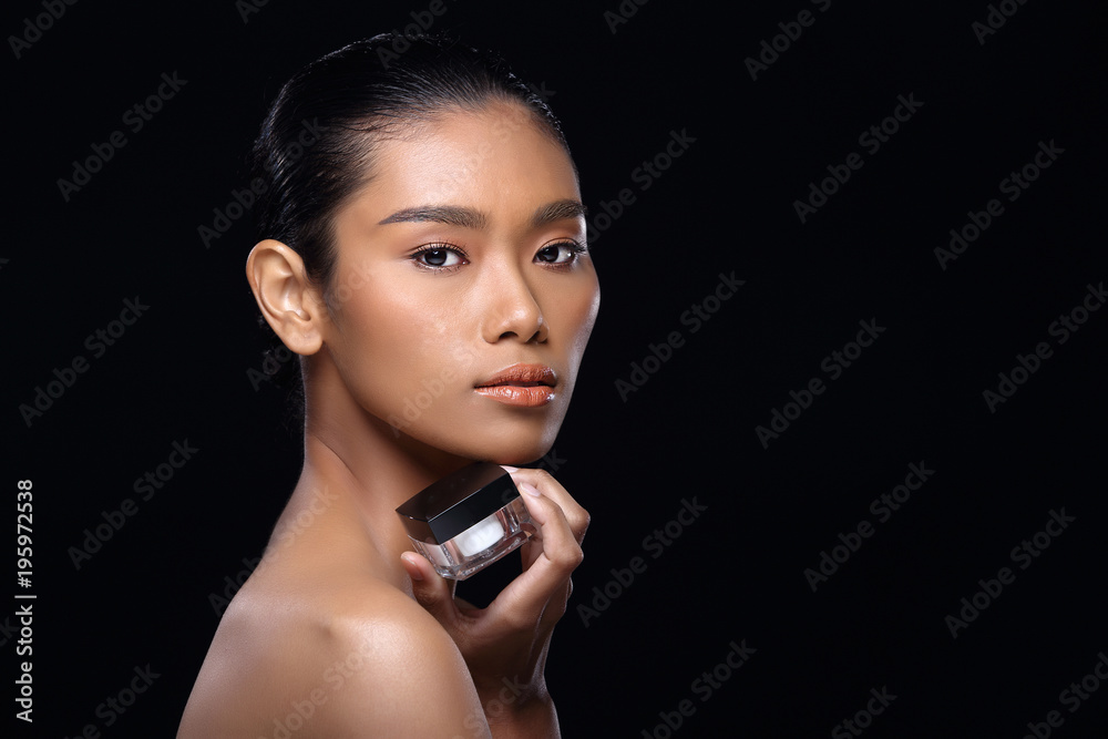 Tanned skin young fashion Asian woman model present showing treatment package box copy space on her hand palm