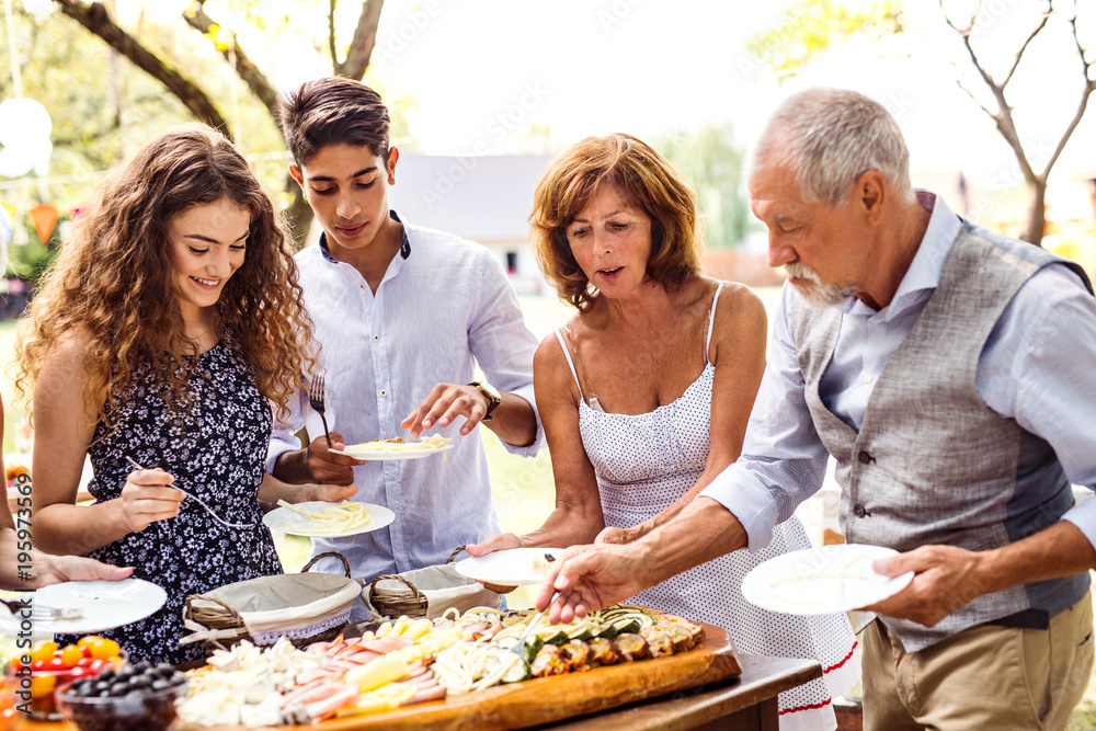 Family celebration or a garden party outside in the backyard. Family celebration or a garden party outside in the backyard.