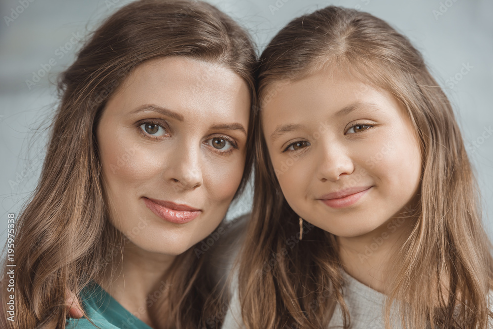portrait of mother and daughter looking at camera portrait of mother and daughter looking at camera