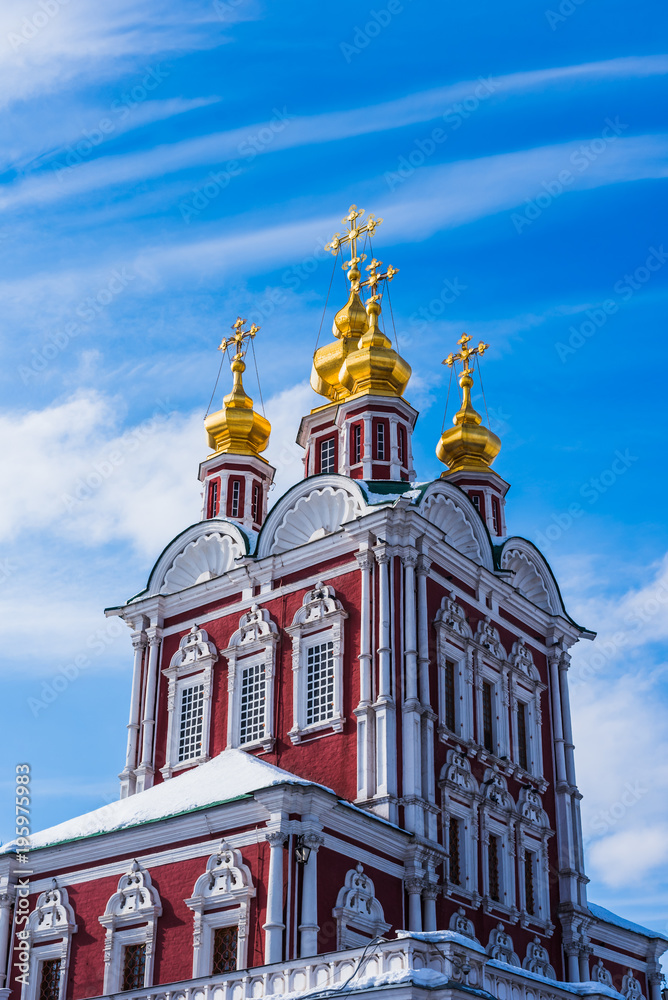Fototapeta premium Golden domes with crosses of old orthodox church on a background of beautiful blue sky