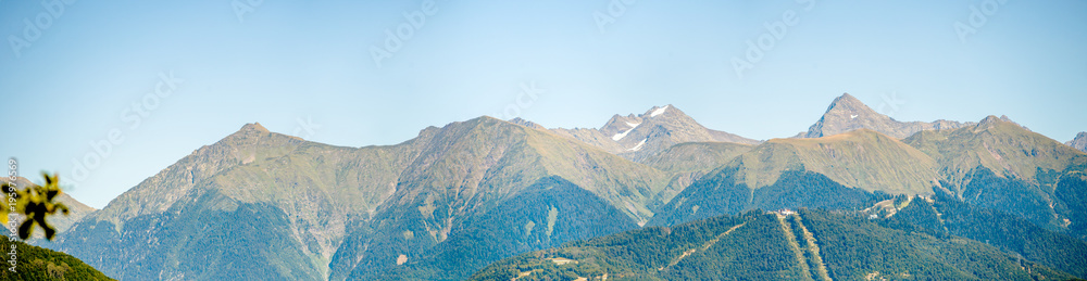 Panoramic photo of mountainous area with green vegetation