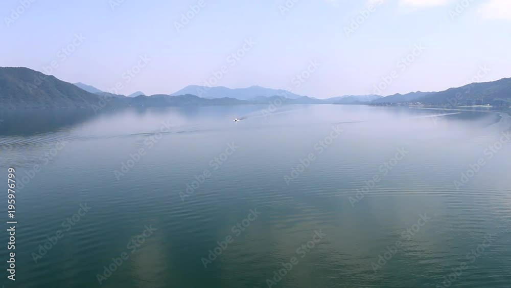 Calm Hazy Lake With Distant Mountains Calm Hazy Lake With Distant Mountains