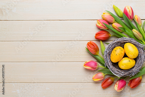 Spring easter tulips in bucket on white vintage background.