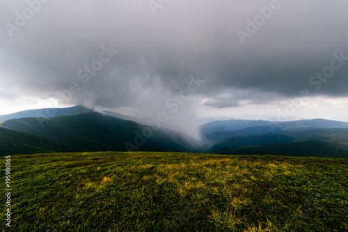 Storm rainy clouds above mountains. Apocalypse fantasy fabulous sky. Beautiful windy dramatic cloudscape at nature. Picturesque scenic view outdoor. Travel in wild territory. Discover rocky hills.