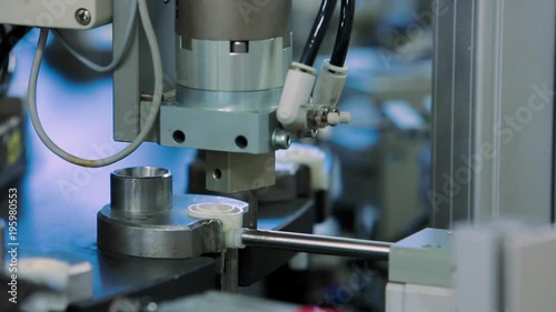 The machine closes the lid on the production of droppers at the medical equipment factory