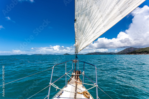 Photography Sail boat on open water around the whitsunday islands in Australia