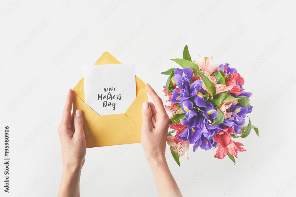 cropped shot of person holding envelope with happy mothers day greeting card and beautiful bouquet of flowers on grey cropped shot of person holding envelope with happy mothers day greeting card and beautiful bouquet of flowers on grey