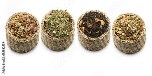 variety of tea blend in straw baskets on white background