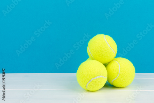 four tennis balls with blue background photo