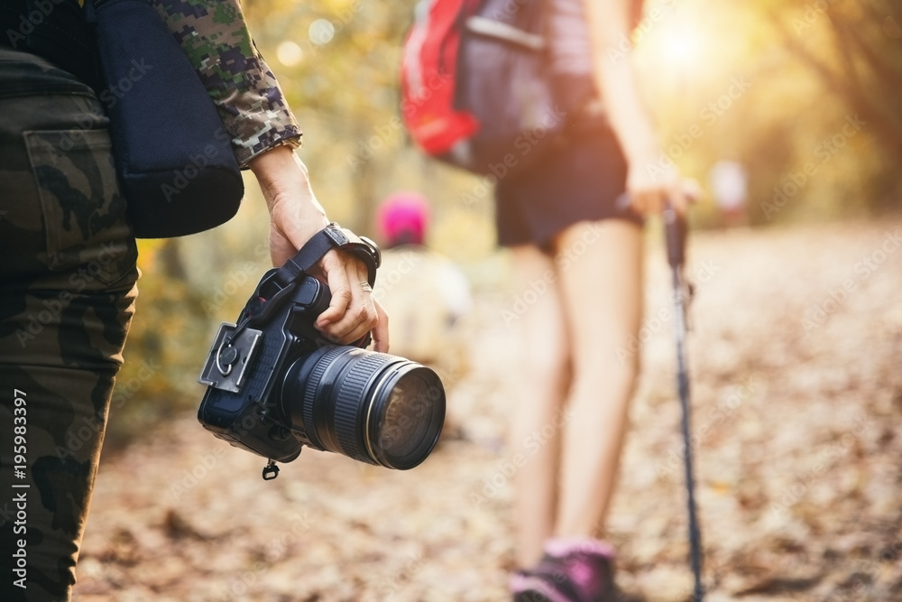 Fototapeta premium Young asian people hiking in the forest during summer at sunset,travel,tourism and teamwork concept