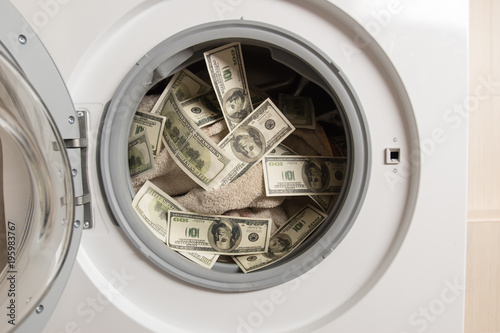 Laundering of dirty money in washing machine. close up. Selective focus.