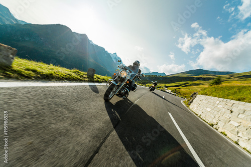 Motorcycle drivers riding in Alpine highway on famous Hochalpenstrasse, Austria, Europe. photo