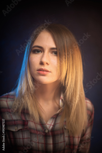 portrait smiling girl on blue background in studio
