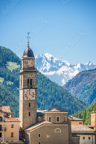 Church of Cogne, Monte Bianco (Mont Blanc) in the background, Grand Paradiso National park, Aosta Valley in the Alps, Italy photo