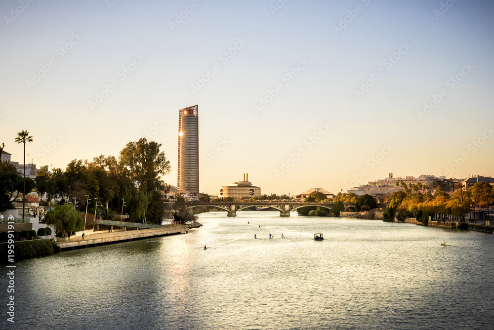 View of Seville Tower (Torre Sevilla) of Seville, Andalusia, Spain over river Guadalquivir at sunset