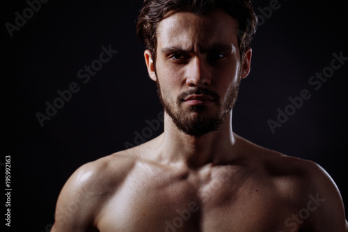 closeup image of man with brown eyes, brown hair, mustache and beard without clothers. swimmer
