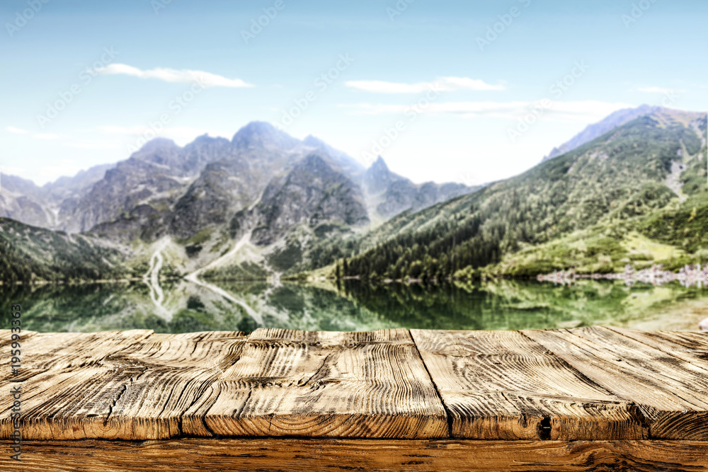 desk of free space and landscape of mountains and lake 