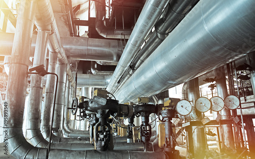 Equipment, cables and piping as found inside of a modern industrial power plant