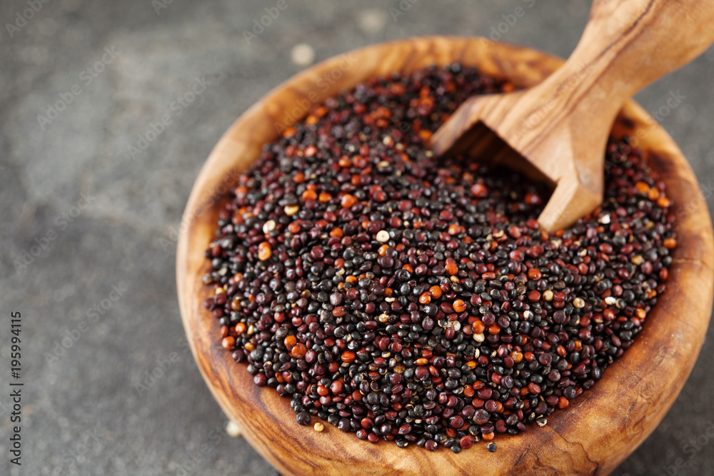 Seeds of black quinoa in wooden bowl copy space Seeds of black quinoa in wooden bowl copy space