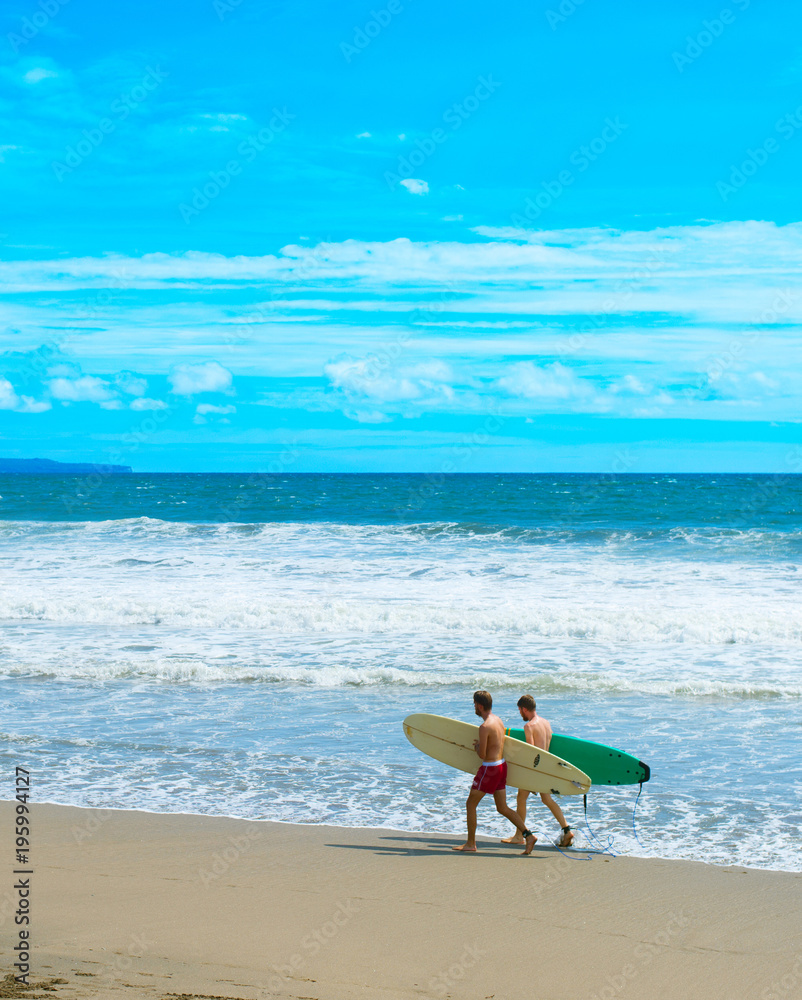 Two surfers on ocean beach