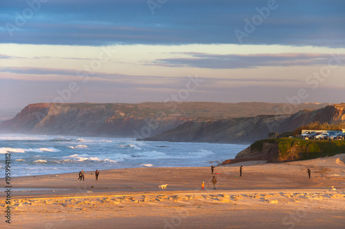 People walking ocean beach Portugal
