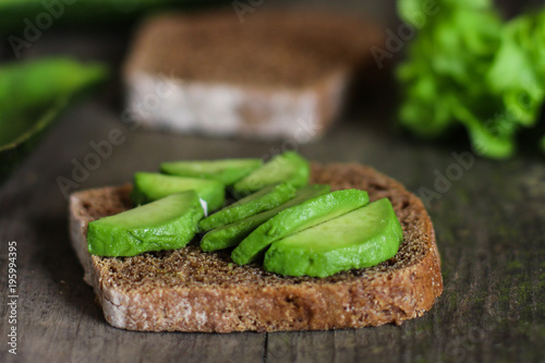 avocado cut into slices  a sandwich with avocado 