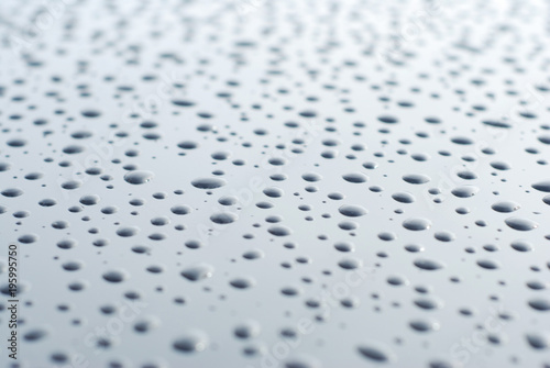 Abstract of Water Rain Drop on Car Glass, Drops over Black Shinny Background.