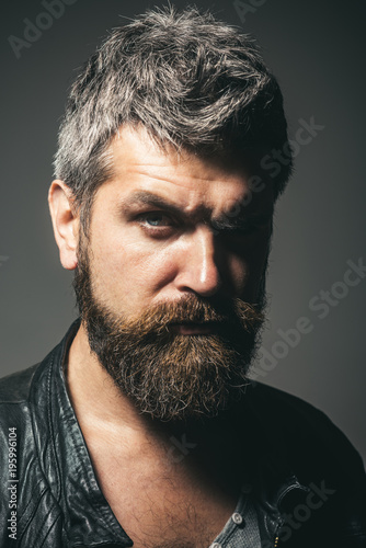 Fashion for men. Seasonal fashion. Portrait of cool seductive sexy unshaven man in black leather jacket. Serious bearded man in leather jacket with stylish hairdo. Fashion look, trendy man. Closeup.