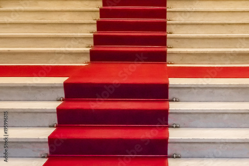 White marble staircase with a red carpet