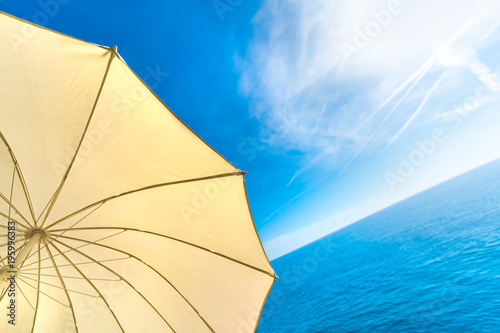 White parasol by the sea