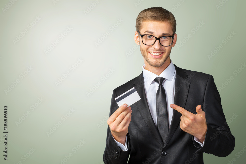Young happy man holding credit card Young happy man holding credit card