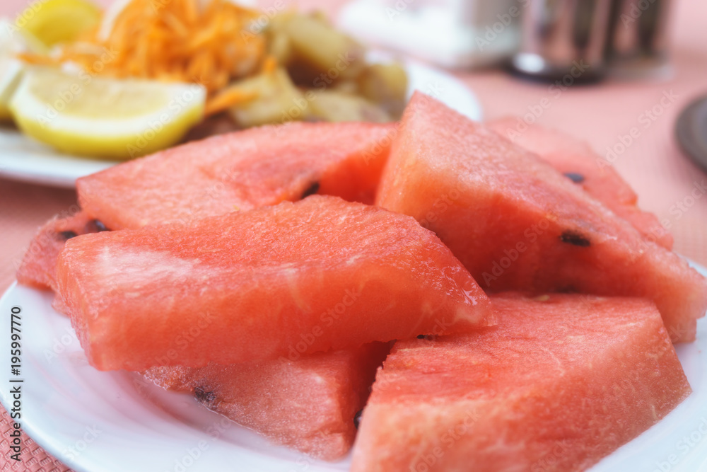Watermelon cut and laid on a plate Watermelon cut and laid on a plate