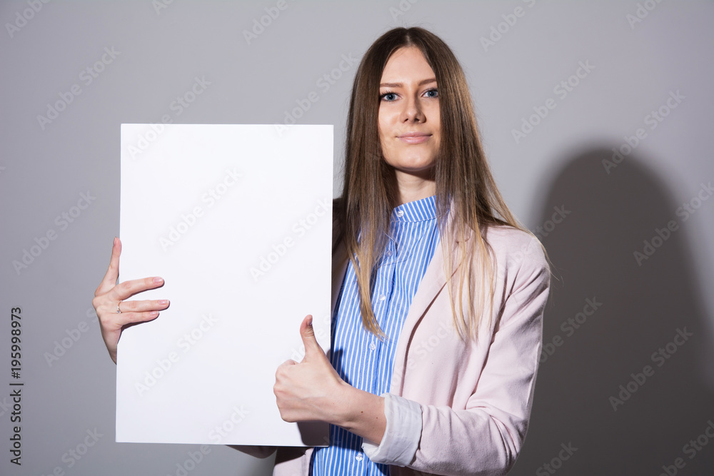 Young woman with white sheet for advertising Young woman with white sheet for advertising
