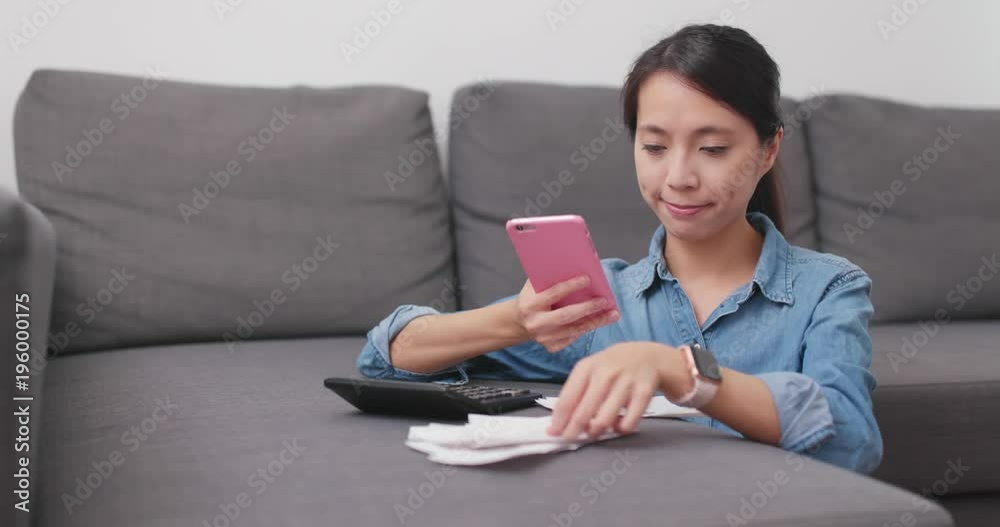 Housewife using cellphone to take photo on receipt and calculate the expenditure of daily life Housewife using cellphone to take photo on receipt and calculate the expenditure of daily life